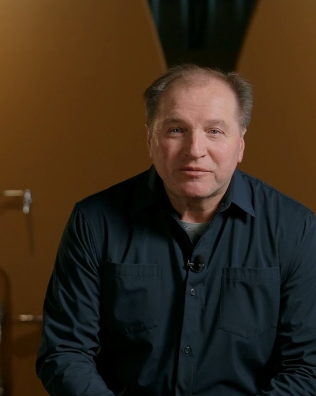 Andrzej Lipinski, founder and winemaker of Big Head Wines, in front of the oak fermenters (still from the family's film)